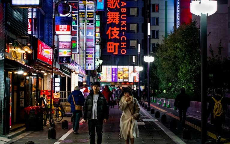 man standing beside woman on street at night
