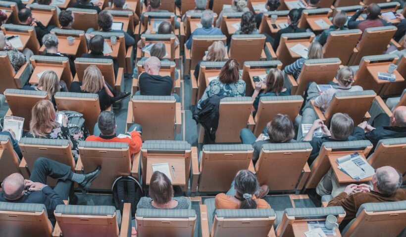 high-angle photography of group of people sitting at chairs